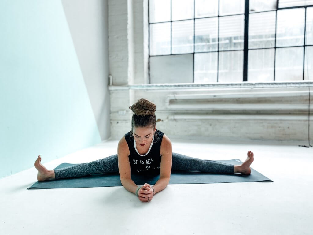 Woman in a Wide-Legged Seated Forward Fold.