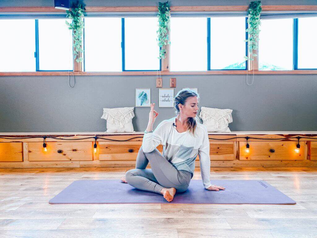 Woman performing a Seated Spinal Twist to aid digestion.